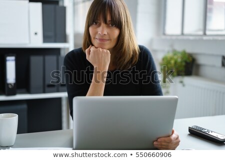 Stockfoto: Pensive Office Worker Sat With Laptop