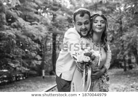 [[stock_photo]]: Woman Holding Flowers In Her Hand Near Man
