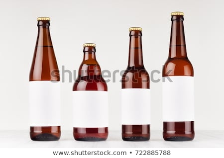 Zdjęcia stock: Brown Nrw Beer Bottle 500ml With Blank White Label On White Wooden Board Mock Up