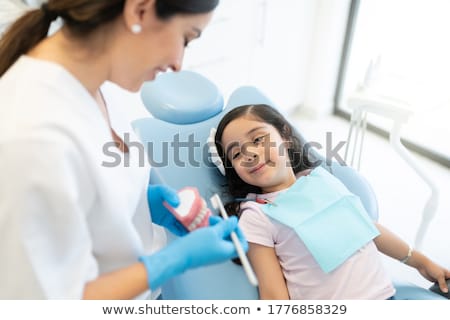 Сток-фото: Dentist Showing Model Teeth To Patient