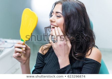 Foto stock: Female Doctor Working On New Teeth Implant
