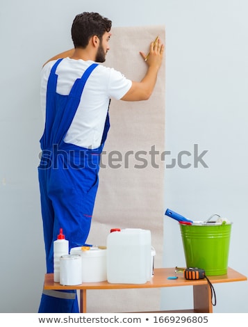 Stock photo: Worker Working On Wallpaper During Refurbishment