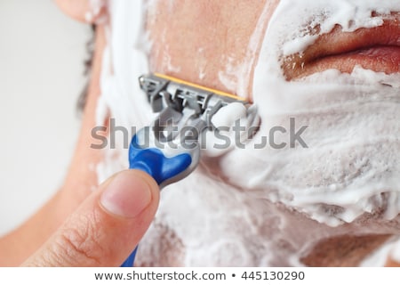 Сток-фото: Close Up Of Man Shaving Beard With Razor Blade