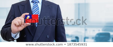 Stok fotoğraf: Businessman Holding Business Card With Taiwan Flag