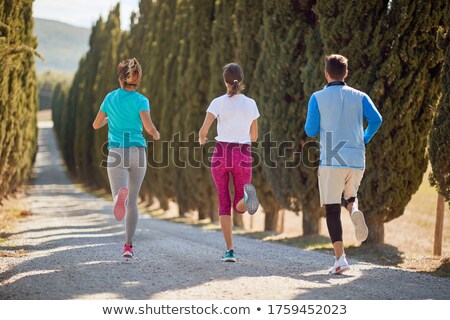 Stock photo: Woman Jogging Down Gravel Road