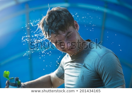 Stock photo: Man Drinking Splashing Water Face