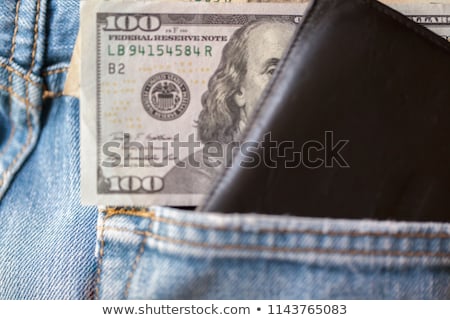 Stock fotó: A Hundred Dollar Bills Sticking In The Back Pocket Of Denim Blac