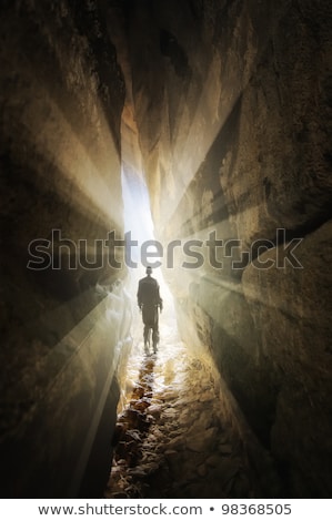 Stock photo: Man Walking Out Of A Cave