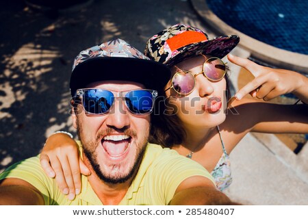 ストックフォト: Man And Woman Taking Self Portraits At Pool