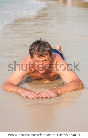 Stock photo: Man In Bathingsuit Is Lying At The Beach