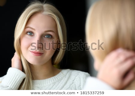 Stock foto: Young Woman Posing Near The Mirror