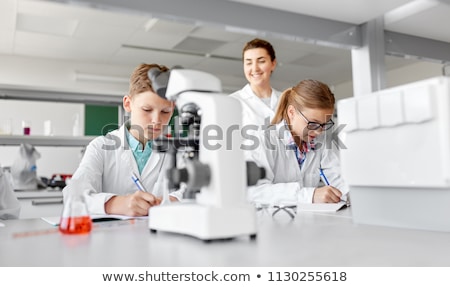 Stock fotó: Boy With Notebook Studying Biology At School