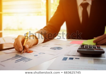 Stock photo: Hand Holding Tablet And Checking Finantial Report Concept