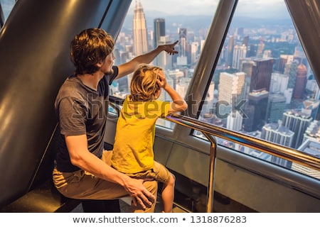 Foto stock: Dad And Son Are Looking At Kuala Lumpur Cityscape Panoramic View Of Kuala Lumpur City Skyline Eveni