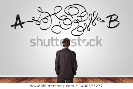 Foto d'archivio: Businessman Looking For Solution While Standing In Front Of A Wall