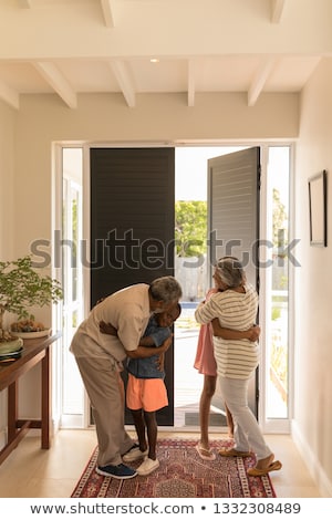 Stock fotó: Front View Of Happy African American Grandparents Hugging Their Grandchildren At Home