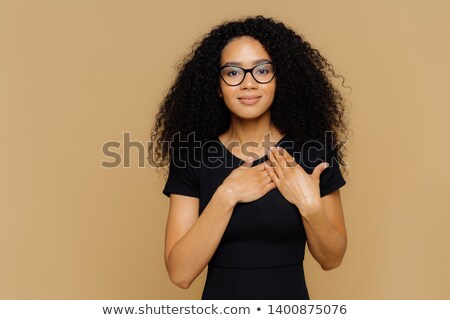 Stock photo: Beautiful Dark Skinned Woman Keeps Palms Near Hear Expresses Gratitude Thankfulness Has Friendly
