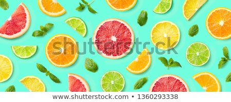 Foto stock: Abstract Green Background With Citrus Fruit Of Lime Slices