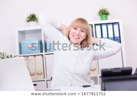 Stock fotó: Blond Woman Stretching At Her Desk