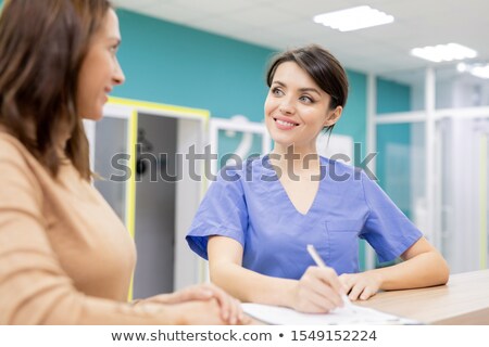 Beautiful Nurse Writing Document Сток-фото © Pressmaster