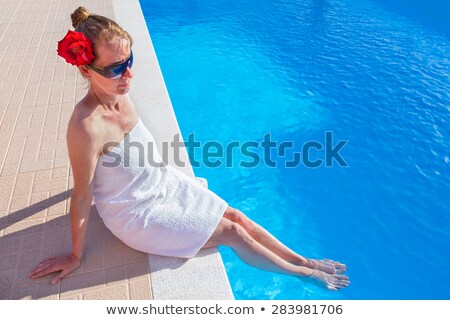 Stock fotó: Caucasian Woman With Rose And Towel At Swimming Pool