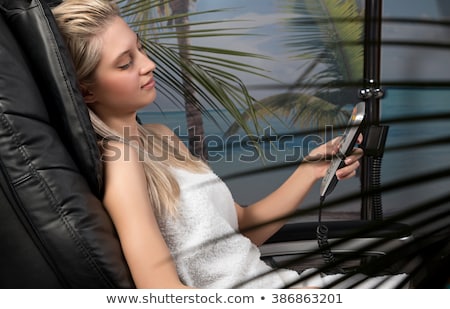 Сток-фото: Woman Sitting In Chair With Remote Control Smiling