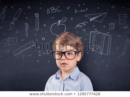 Stock photo: Little Boy In Front Of A Drawn Up Blackboard