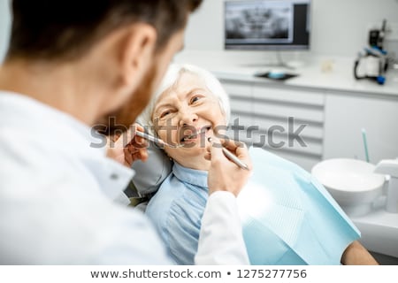 Foto stock: Woman Dentist Working On Teeth Implant