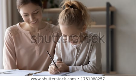 Stock foto: A Teacher A Tutor For Home Schooling And A Teacher At The Table Or Mom And Daughter Homeschooling