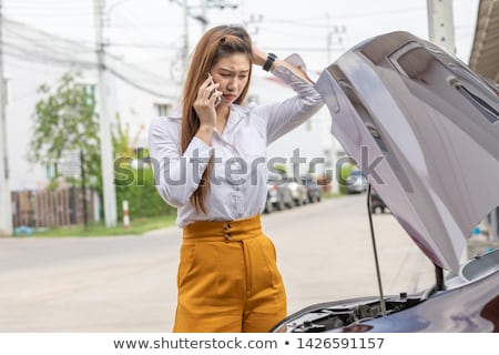 ストックフォト: Young Woman Standing By Her Damaged Car And Calling For Help