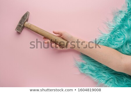 Stock photo: A Tired Female Construction Worker With A Hammer