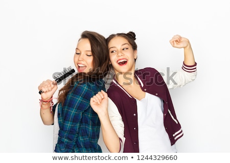 Foto stock: Two Girl Singing Into Hairbrush