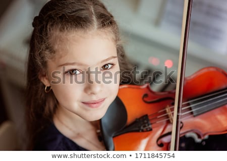 Stock photo: Young Girl Learning To Play Violin