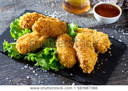 Stok fotoğraf: Fried Chicken In Batter On A Wooden Background