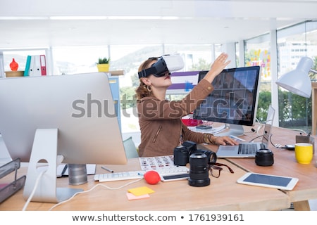 Zdjęcia stock: Female Executive Working On Laptop While Using Virtual Reality Headset