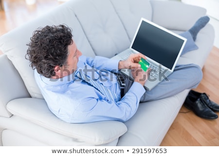 Foto d'archivio: Male Executive Doing Online Shopping On Laptop