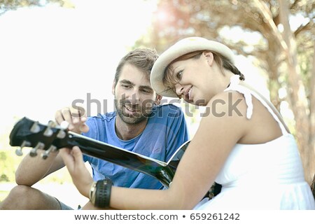 Zdjęcia stock: Man Teaching Girlfriend Guitar Outdoors