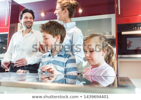 ストックフォト: Children Checking Out The New Kitchen Their Parents Are About To Buy