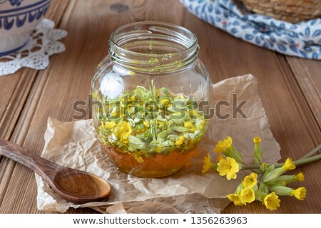 [[stock_photo]]: Preparation Of A Syrup From Primrose Flowers And Honey