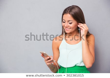 Сток-фото: Portrait Of Attractive Woman Using Smart Phone To Listen To Music