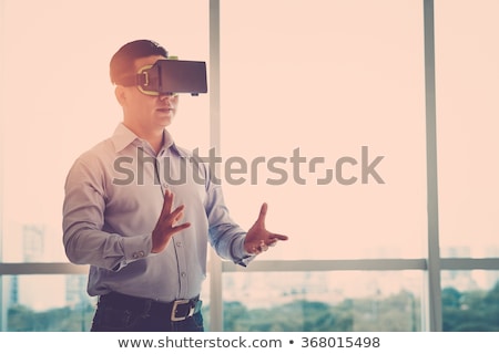 Stok fotoğraf: Businessman With Virtual Reality Headset At Office