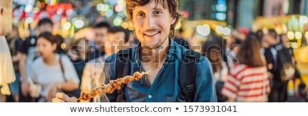 Foto d'archivio: Young Man Tourist On Walking Street Asian Food Market Banner Long Format