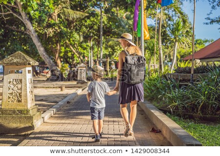 Stockfoto: Woman Traveler Discovering Sanur Bali Indonesia Traveling With Children Concept