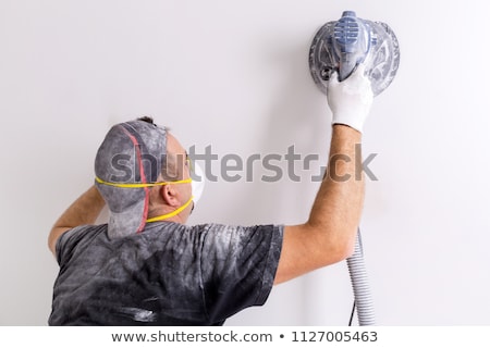 Stock photo: Plasterer Smoothing Interior Wall With Machine