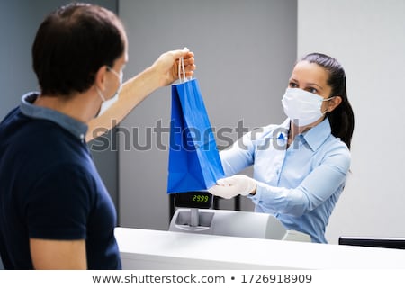 Foto stock: Cashier In Retail Shop Or Store At Counter