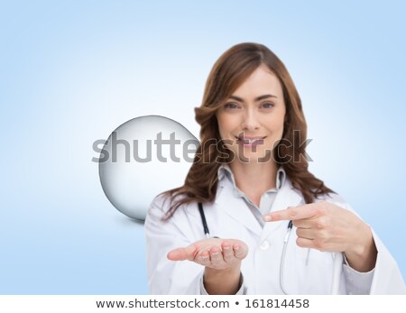 Foto d'archivio: Attractive Female Doctor Pointing Her Finger