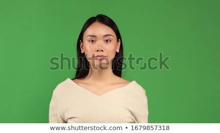 Foto stock: Young Serious Attractive Woman Looking Into The Camera