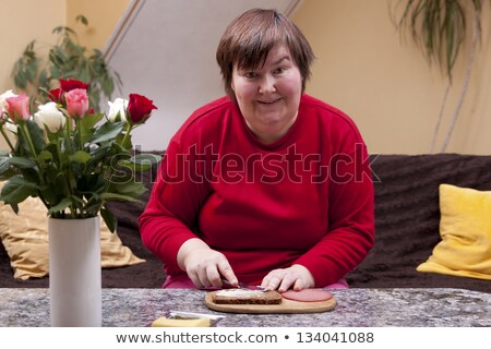 Foto stock: Mentally Disabled Woman Is Making Up A Sandwich