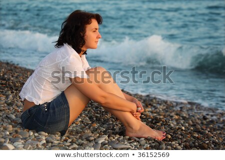 Stock fotó: Brunette Woman Sitting On Stone Beach