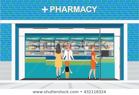 Foto d'archivio: Pharmacist At Counter In Pharmacy Opposite Shelves With Medicines